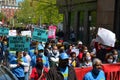 Crowd of activists with signs marching during May Day Parade at Washington Square Park in NYC