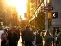 Crowd of anonymous people walking down the busy sidewalk in Manhattan with bright sunlight shining in New Royalty Free Stock Photo