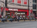 Crowd and bikes in front of Shanghai Five Guys Restaurant in Huaihai Road, China Royalty Free Stock Photo