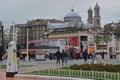 Crowd, birds at secular Republic Monument, Taksim Square, Beyoglu district Istanbul Turkey with Hagia Triada Greek Orthodox Church Royalty Free Stock Photo