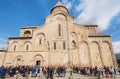 Crowd celebrating the City Day past the historical christian Svetitskhoveli Cathedral. UNESCO World Heritage Site.