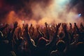 Crowd cheering at a music festival and raising hands in the air Royalty Free Stock Photo