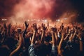 Crowd cheering at a music festival and raising their hands in the air Royalty Free Stock Photo