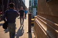 Crowd of commuters pass each other on Lake St bridge in Chicago Loop during morning commute
