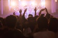 Crowd at concert and blurred stage lights, noise added later in