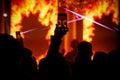 Smartphone filming live concert with bright orange flames on screen Royalty Free Stock Photo