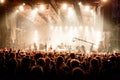 Crowd at concert - Cheering crowd in front of bright colorful stage lights Royalty Free Stock Photo