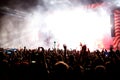 Crowd at concert - Cheering crowd in front of bright colorful stage lights Royalty Free Stock Photo