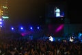 Crowd at concert music festival. Happy people raising hands up