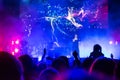 Crowd at concert. People silhouettes on backlit by bright blue and purple stage lights. Cheering crowd in colorful stage lights. R Royalty Free Stock Photo