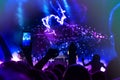 Crowd at concert. People silhouettes on backlit by bright blue and purple stage lights. Cheering crowd in colorful stage lights. R Royalty Free Stock Photo