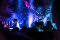 Crowd at concert. People silhouettes on backlit by bright blue and purple stage lights. Cheering crowd in colorful stage lights. R Royalty Free Stock Photo