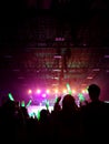 Blurred crowd at concert : Silhouette people crowd happy and cheering with led foam stick light.