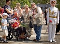 Crowd congratulates veteran woman during Victory Day celebration