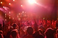 Crowd dancing to music during concert in neon lights Royalty Free Stock Photo