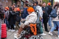 People in orange clothing are sailing in a boat on the canals of Amsterdam on King\'s Day