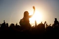 The crowd enjoys the summer music festival, sunset, the silhouettes hands up Royalty Free Stock Photo