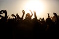 The crowd enjoys the summer music festival, sunset, the silhouettes hands up Royalty Free Stock Photo