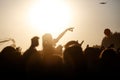 The crowd enjoys the summer music festival, sunset, the silhouettes hands up Royalty Free Stock Photo