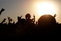 The crowd enjoys the summer music festival, sunset, the silhouettes hands up Royalty Free Stock Photo