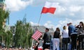 Crowd enthusiastically wave flags. Krasinski Square.