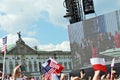 Crowd enthusiastically wave flags