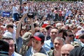 Crowd enthusiastically wave flags