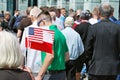 Crowd enthusiastically wave flags