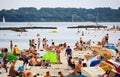 Crowd of European people swimming and sunbathing in beach at University of Kiel in summer
