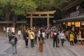 Crowd in front of the wooden Higashi-Tamagaki-Torii sacred gate of Shinto Meiji-Jingu shrine.