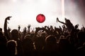 Party people with hands in the air at a big dance event