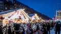 Crowd gathered at festive market stalls during the Christmas season in Paris