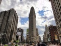 A crowd gathers beneath the towering Flatiron Building against the urban sky New York USA Royalty Free Stock Photo