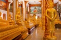 Crowd of golden Buddha statues in different poses inside Wat Chalong temple Royalty Free Stock Photo