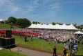 Crowd and graduates sit in front of tent at outdoor Wesleyan University Graduation Middletown Conneticut USA circa May 2015