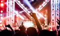 Crowd of hands up concert stage lights Royalty Free Stock Photo