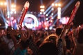 Crowd of hands up concert stage lights and people fan audience silhouette raising hands in the music festival rear view with Royalty Free Stock Photo