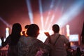 Crowd of hands up concert stage lights and people fan audience silhouette raising hands in the music festival rear view with Royalty Free Stock Photo