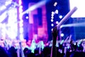 Crowd of hands up glow stick concert stage lights Royalty Free Stock Photo
