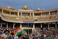 A crowd of Indian people in the stands with flags during the closing ceremony of the border between India and Pakistan.