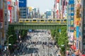 Crowd of Japanese people and the tourist walking and shopping with car traffic at Akihabara district Tokyo Japan