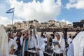 Crowd of Jewish worshipers in white wearing