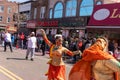 Crowd of joyous people celebrating the Indian Holi festival in Queens, United States.