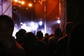 Crowd of man in concert or festival. Defocus cheering crowd and stage lights. Silhouette of people in music concert with