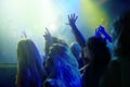 Crowd, neon lights and people at concert or music festival dancing with energy and hands up at night event. Dance, fun Royalty Free Stock Photo