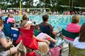 Crowd Of Parents Sit Poolside To Watch Swim Meet