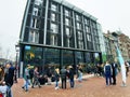 Crowd of people of acculturated tourists lining up to visit the Anna Frank house building and Amsterdam museum in winter