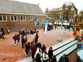 Crowd of people of acculturated tourists lining up to visit the Anna Frank house building and Amsterdam museum in winter