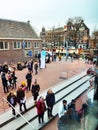 Crowd of people of acculturated tourists lining up to visit the Anna Frank house building and Amsterdam museum in winter