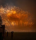 Crowd of people admiring the vibrant display of fireworks lighting up the night sky